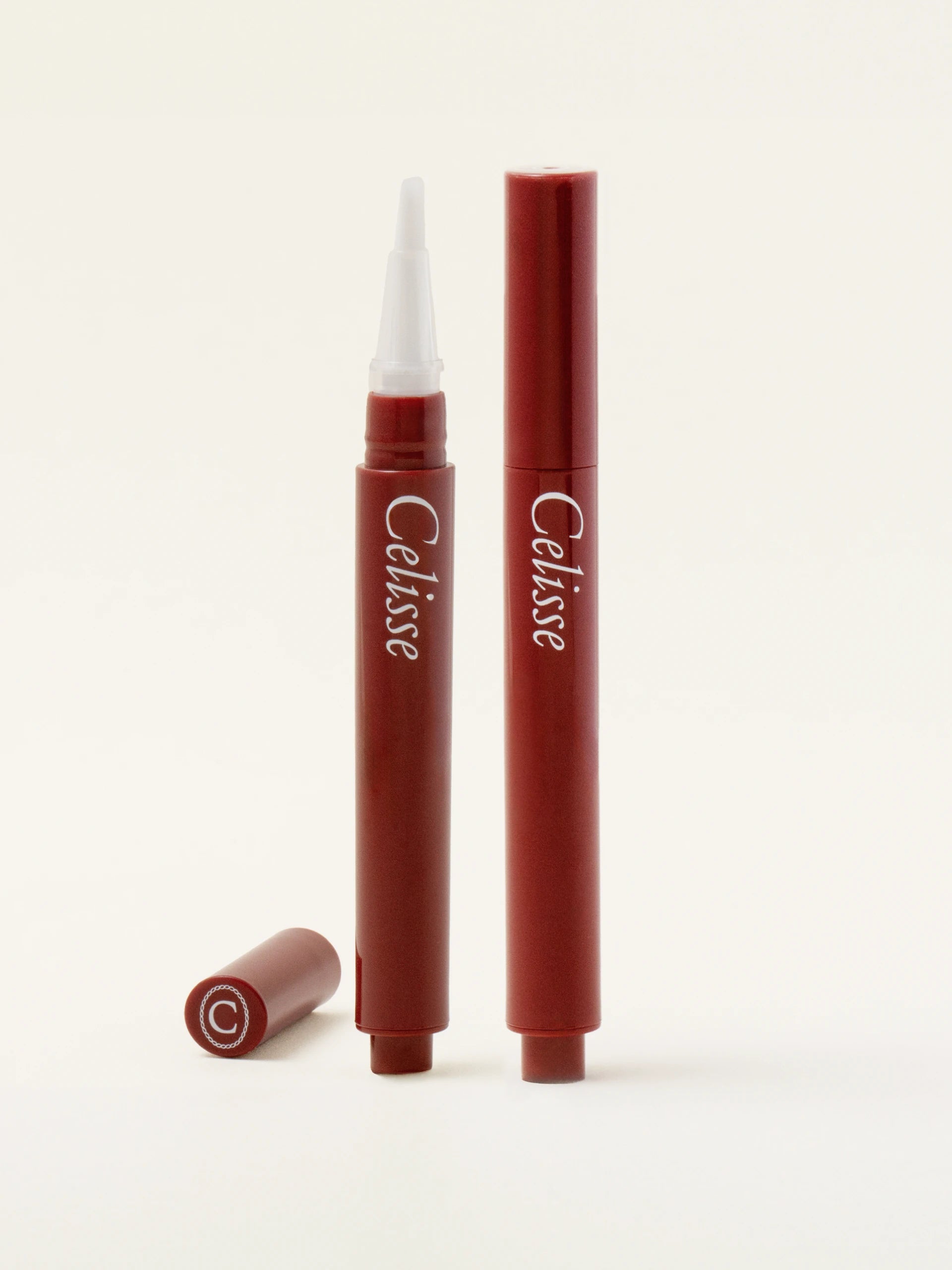 Two Celisse cuticle pens on a white background